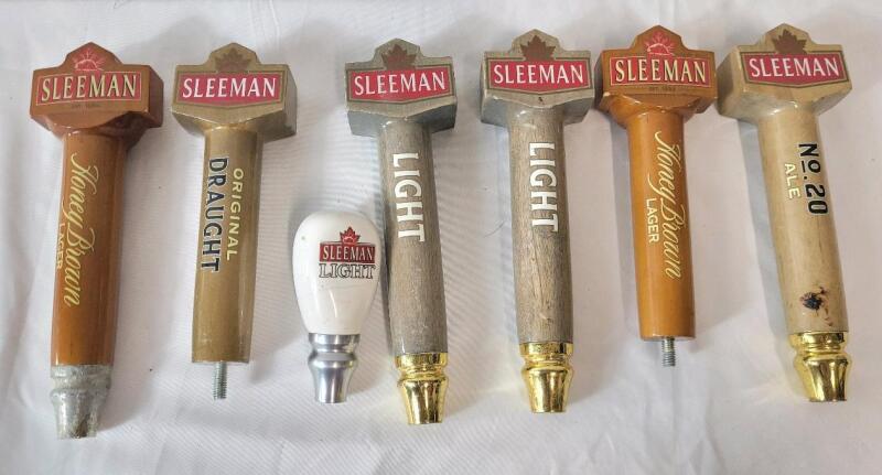 Seven (7) Sleeman Beer Taps . Measures 4.5" - 9.5" tall . Taps have wear from use .