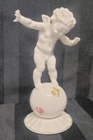 Vintage Hutschenreuther Kunstabteilong Porcelain Figurine Of Cherub On Ball . Measures 5 ⅞" tall .