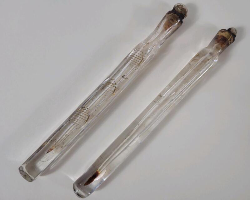 Antique Glass Scent Bottles, also known as " Oxford Lavender " / " Tear Catchers " . Measures 8" & 7 ⅞" long .