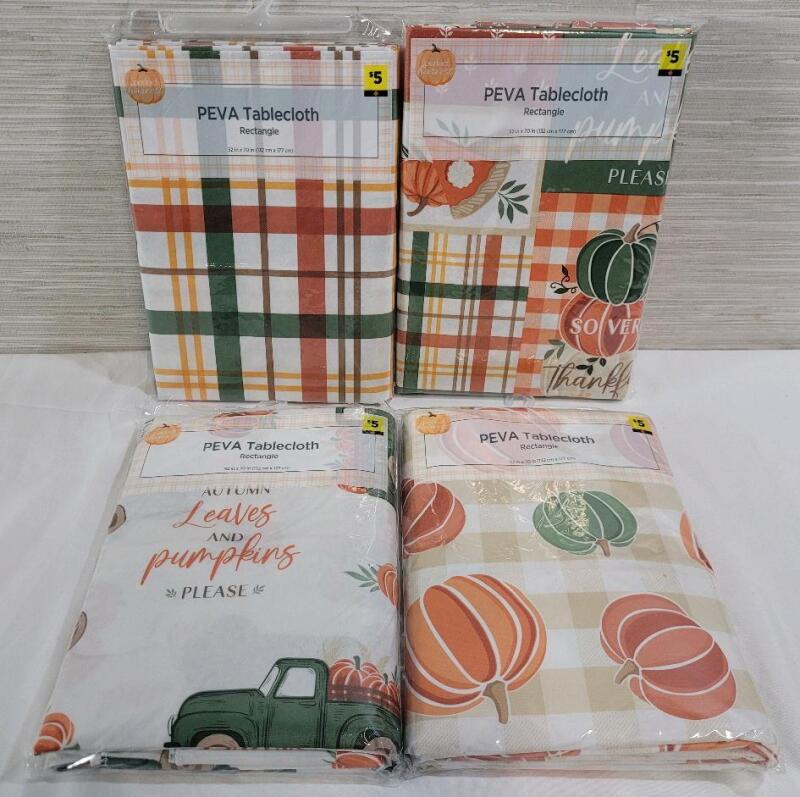 Four (4) New Seasonal Tablecloths . Each measures 52"&times;70" .