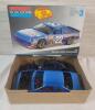 Two (2) 1/25 Scale Race Car Model Kits . One (1) Unstarted - Sealed & One (1) Started - 3