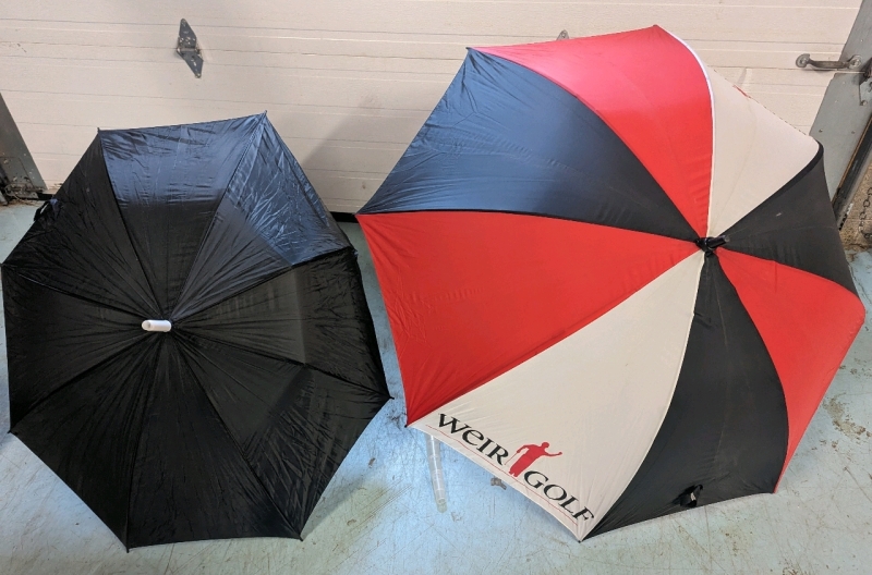 2 Umbrellas. Larger one is Weird Golf Branded.