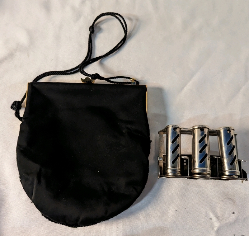 Snap top purse and coin dispenser.