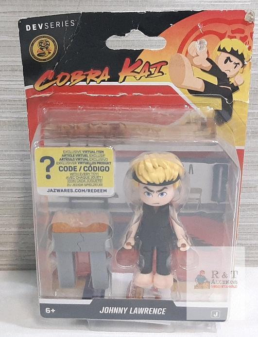 As New Cobra Kai Johnny Lawrence Figure | Packaging Has Noticeable Tears, Does Not Impact Product. Sold As Is
