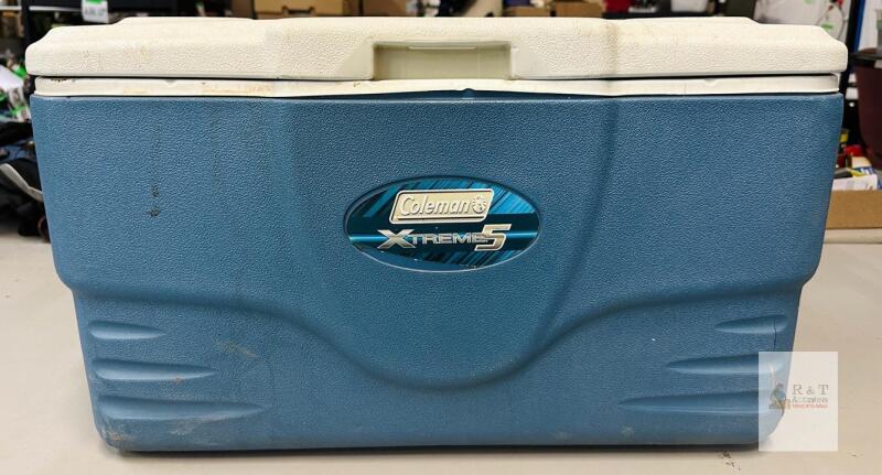 Coleman Xtreme 5 70-Quart Cooler, Blue, 28.5"x15.8"x15.5", 5-Day Ice Retention, Drain Plug, , notable for exterior dirt, scratches, and a crack on the lower corner.