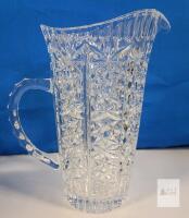 Vintage Heavy Cut Crystal Water Pitcher with Starburst Pattern . Measures 9.5" tall