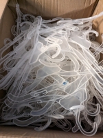 3 Boxes Filled With Plastic Coat Hangers.