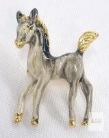 Vintage Enameled Foal / Colt Brooch featuring a Grey and Black Marbled Body with Gold-Tone Accents on the Hooves, Mane, and Tail