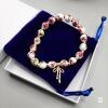 Floral Porcelain Bead Stretch Bracelet with Gold-Tone Bow Charm and Velvet Gift Pouch
