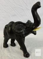 Glossy Black Elephant Figurine with Raised Trunk and Cream Tusks